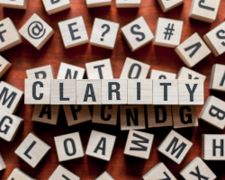 Blocks of letters that spell out "Clarity" (Success for the Athletic-Minded Man podcast episode #441 (Pt 2 of 5) The First Step to Success: Clarifying Your Vision and Values)
