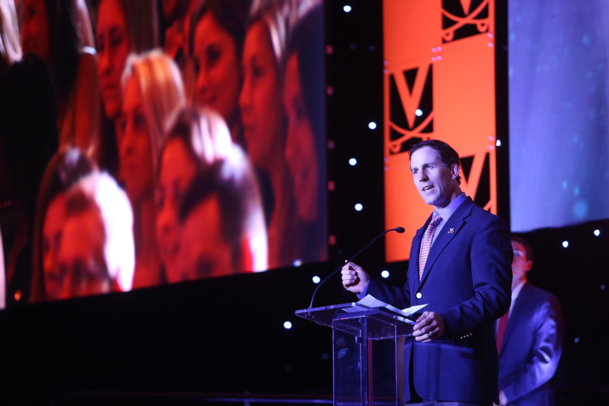 Jim Harshaw Jr. speaking on stage at a University of Virginia event